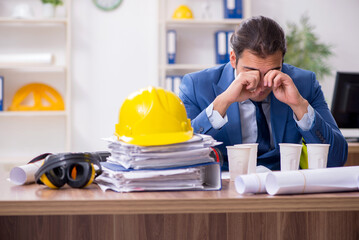 Young male architect working in the office