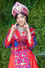 portrait of Hmong young woman in tradition Hmong costume for young girl; Asian ethnic tribal people in traditional colorful clothing culture of Hmong or Miao people in east Asia and southeast Asia