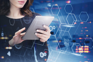 Businesswoman using tablet in night city