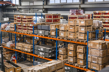 Warehouse with racks and shelves, filled with wooden boxes on pallets. Distribution products....