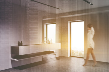 Woman walking in white bathroom