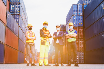 Portrait group of smart creative workers wear protective face masks, safety helmet and uniform for...
