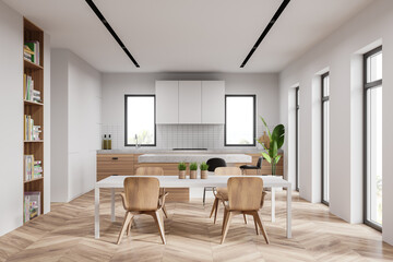 White kitchen interior with bar and table