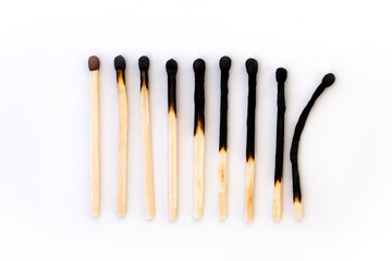 diagonal burnt matches on a white background