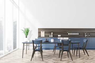 White kitchen interior, blue countertops, table
