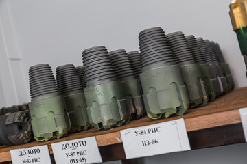 Drill Bits on shelving in stock. Oil equipment for drilling rig operation on oil platform in oil and gas industry. Brand new drilling bits. Written: drill bits