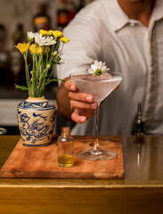 Barman is decorating a cocktail. Bartender is preparing delicious cocktail