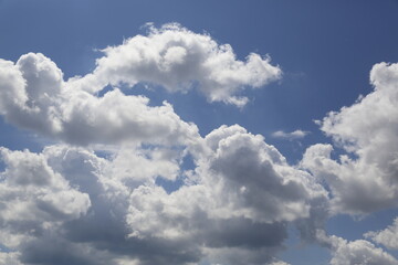 white fluffy clouds in the blue sky.