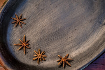Star anise on black table. Lay flat. Copy space