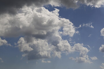 white fluffy clouds in the blue sky.