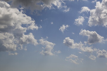 white fluffy clouds in the blue sky.