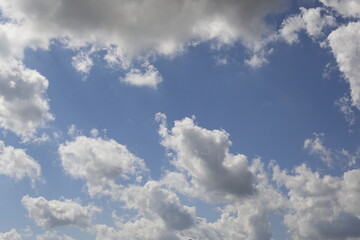 white fluffy clouds in the blue sky.