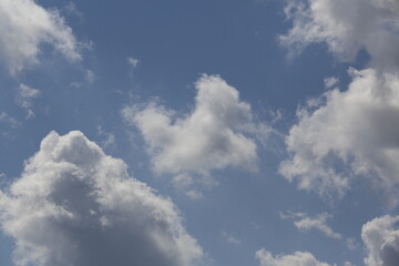 white fluffy clouds in the blue sky.