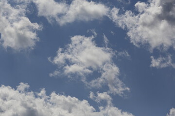 white fluffy clouds in the blue sky.