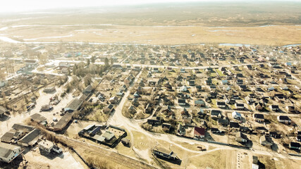 Obraz premium top view of the village: houses, roads, streets. In the background is the horizon. Zarichne village, spring