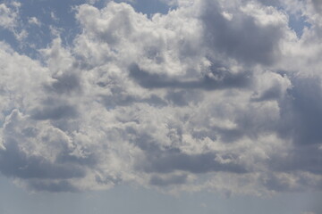 white fluffy clouds in the blue sky.