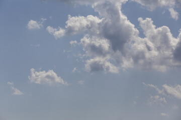 white fluffy clouds in the blue sky.