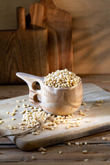 Cedar nuts in wooden pot on rustic background 