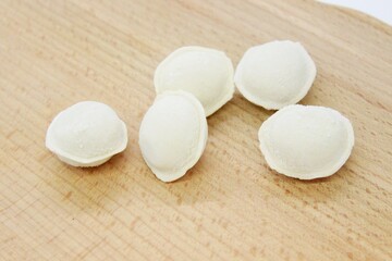Beautiful dumplings located on a wooden surface