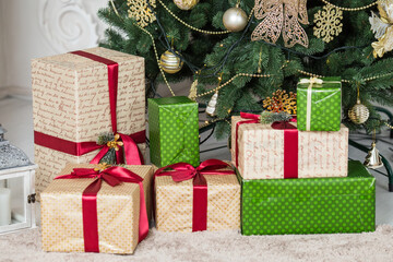 
Gift boxes under the Christmas tree, closeup shot under pulsed lighting.