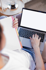 Online education. The girl is sitting in a chair with a laptop and notebook engaged with the teacher online. Online lessons. Online language lessons.