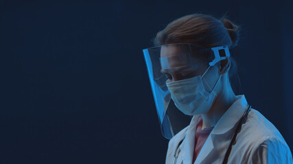 Portrait of Caucasian female doctor posing in a medical mas and face shield