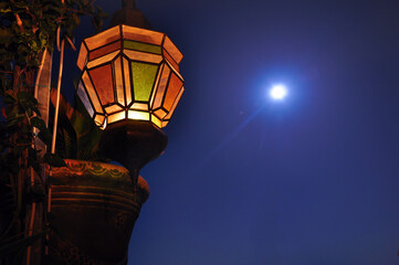 Street lamp against the Moon at night.