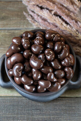 Cashew nuts in chocolate glaze in round bowl