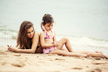 Sisters relaxing together on the beach