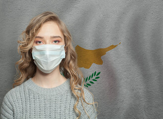 Young woman wearing a face mask with Cyprus  flag. Flu epidemic and virus protection concept