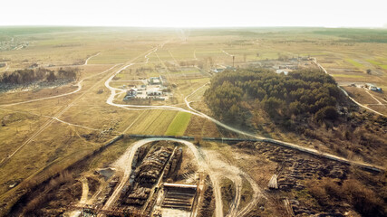 View from the drone on the processing plant, cemetery, landing and narrow gauge railway. Sunny spring day. Zarichne village, Polissya, Ukraine