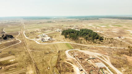 View from the drone on the processing plant, cemetery, landing and narrow gauge railway. Sunny spring day. Zarichne village, Polissya, Ukraine