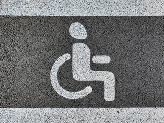 New disabled person sign painted on the new asphalt. Close up view
