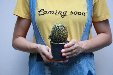 young woman holding a cactus pot
