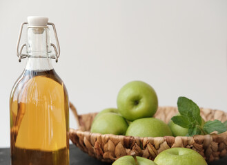 Apple vinegar. Bottle of Homemade apple organic vinegar or cider on grey background. Healthy organic food for weight loss. fermented food fot gut and heart health. copy space for text.