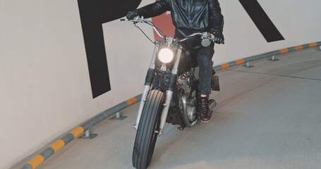 Biker riding on motorcycle in parking lot