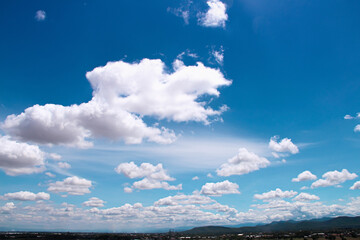 Cloudy summer on bright blue sky outdoor background