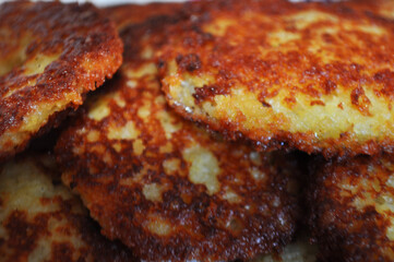 hot fried potato pancakes with potatoes on a blur background