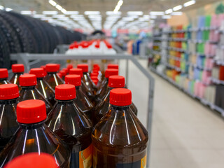 Plastic bottles on the counter in the supermarket. Blurred background of the photo.