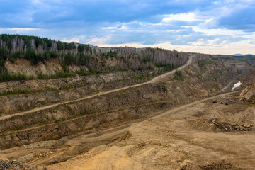 The production of graphite. Deep quarry for the extraction of minerals.