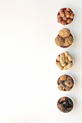 Fototapeta na wymiar Healthy snacks nuts and dried fruits. Top view of bowls on table.