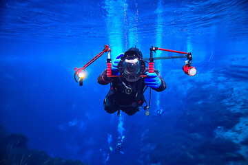 underwater photographer with a camera, diver hobby special underwater boxing with a camera