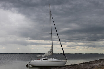 sailboat on the beach on the storm clouds background 