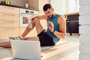 Handsome young man using modern laptop for online communication