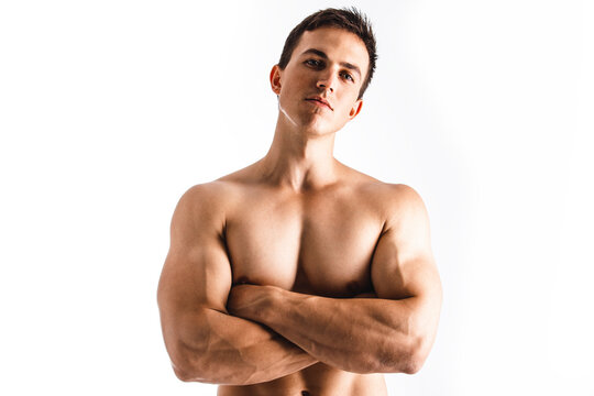 Portrait of a muscle handsome young man posing on white background. Perfect body. Close up. Studio shot