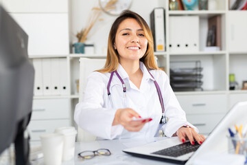Fototapeta na wymiar Latino female doctor working with patient