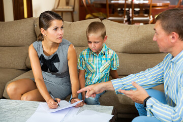 Woman with preteen son signing apartment lease