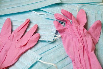 a lot of disposable medical masks on top are disposable gloves, virus protection