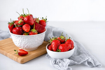 Heap of fresh strawberries in ceramic bowl