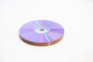 A stack of CDs DVDs - Blank recordable DVDs (DVD-R) purple discs on white background